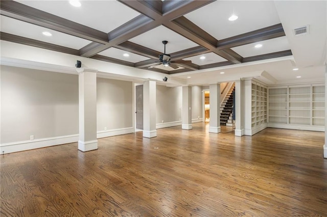 unfurnished living room with beam ceiling, visible vents, ceiling fan, wood finished floors, and ornate columns