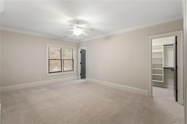 unfurnished bedroom with baseboards, ornamental molding, and light colored carpet