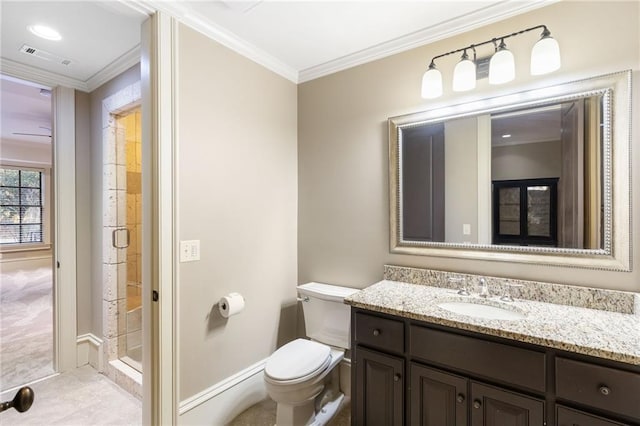 bathroom featuring toilet, visible vents, vanity, a shower stall, and crown molding