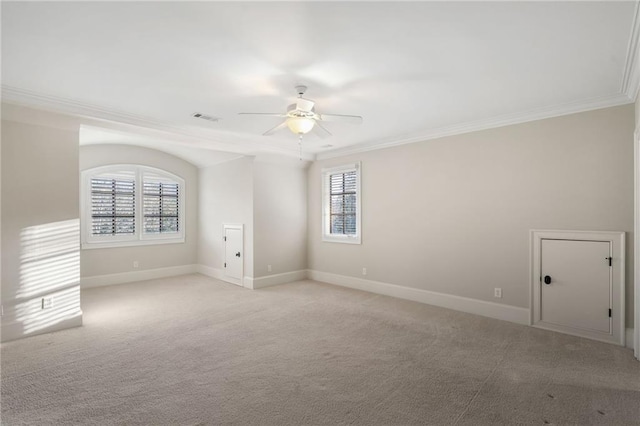 empty room featuring ornamental molding, light colored carpet, and visible vents