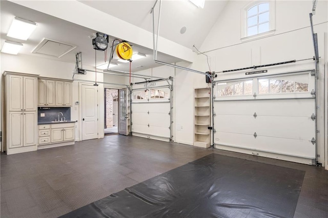 garage with a sink and a garage door opener