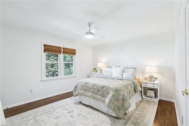 bedroom with ornamental molding, a ceiling fan, baseboards, and wood finished floors