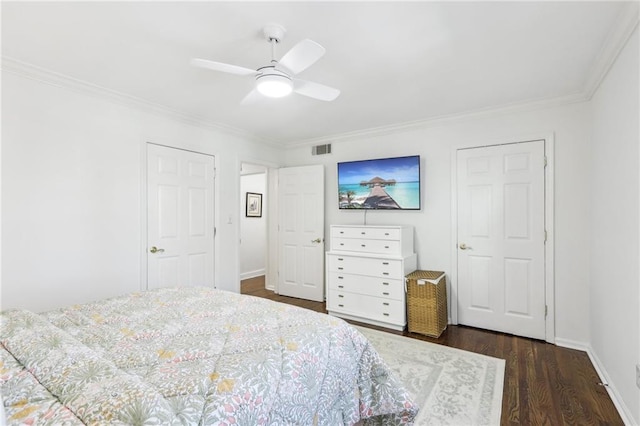 bedroom featuring visible vents, baseboards, dark wood-type flooring, and crown molding