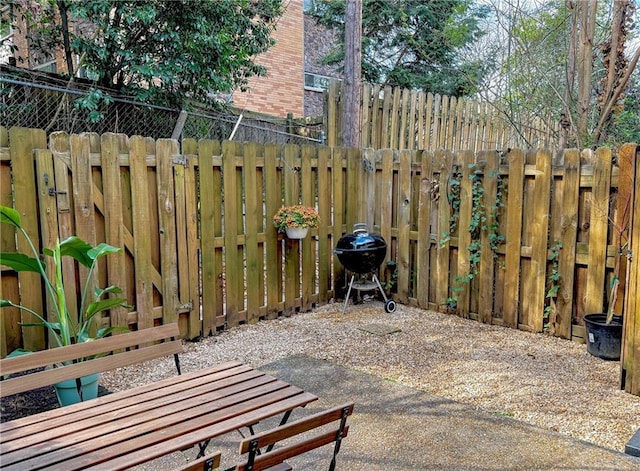 view of patio featuring a fenced backyard and a grill