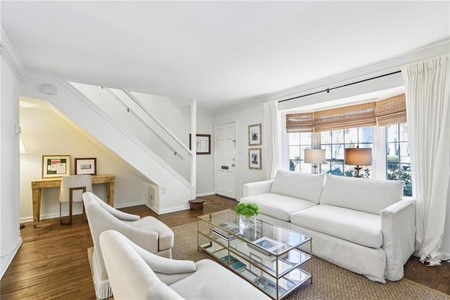 living room with stairway, crown molding, baseboards, and wood finished floors