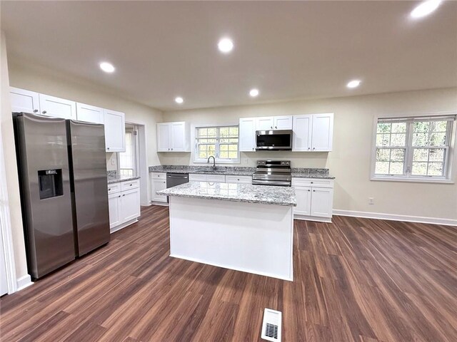 2182 Rosewood Rd, Decatur, GA 30032 - kitchen with visible vents, a sink, dark wood-type flooring, and appliances with stainless steel finishes