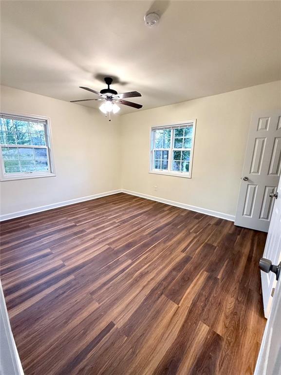 2182 Rosewood Rd, Decatur, GA 30032 - spare room with dark wood finished floors, baseboards, and ceiling fan