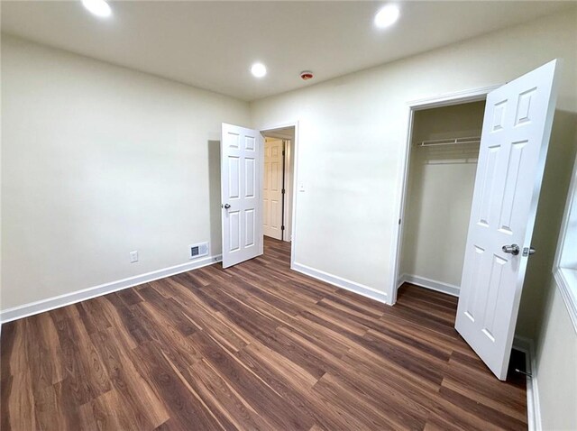 2182 Rosewood Rd, Decatur, GA 30032 - unfurnished bedroom with a closet, baseboards, dark wood-style flooring, visible vents, and recessed lighting