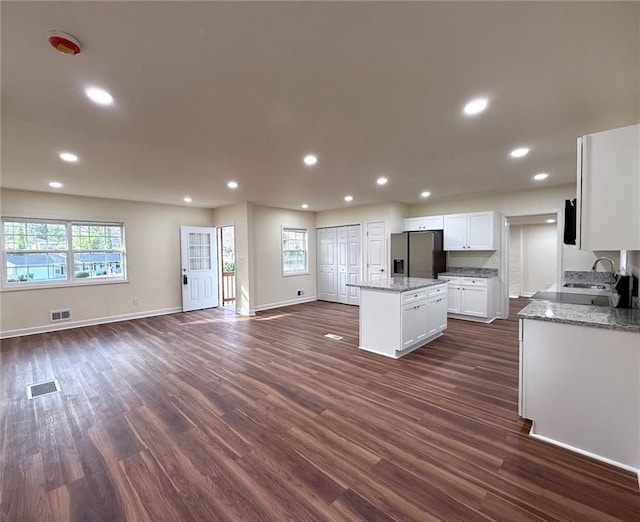 2182 Rosewood Rd, Decatur, GA 30032 - kitchen with stainless steel fridge with ice dispenser, dark wood-style flooring, visible vents, and a kitchen island