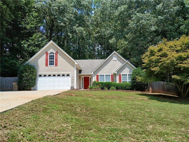 view of front of home with a front yard and a garage