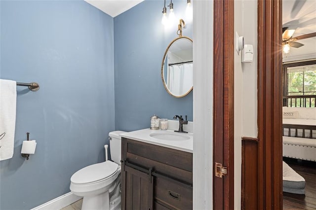 161 N Barton St, Norcross, GA 30071 - bathroom with vanity, toilet, wood finished floors, ceiling fan, and baseboards