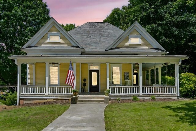 161 N Barton St, Norcross, GA 30071 - farmhouse featuring covered porch and a lawn