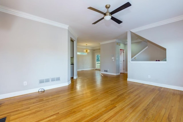 unfurnished living room featuring ceiling fan with notable chandelier, ornamental molding, and light wood-type flooring