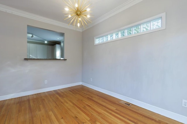 unfurnished room with crown molding, an inviting chandelier, and light hardwood / wood-style floors