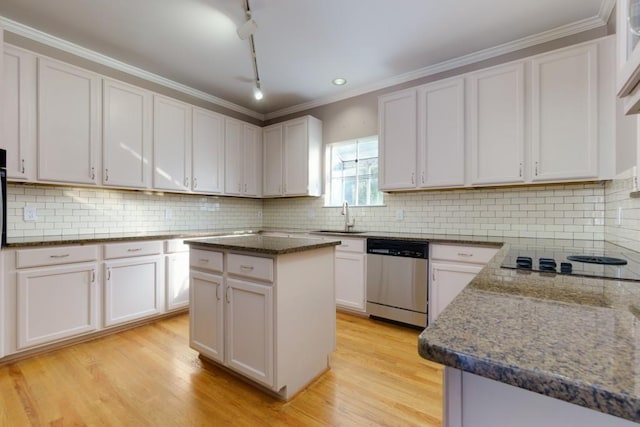 kitchen with stainless steel dishwasher, black electric stovetop, white cabinetry, and a kitchen island