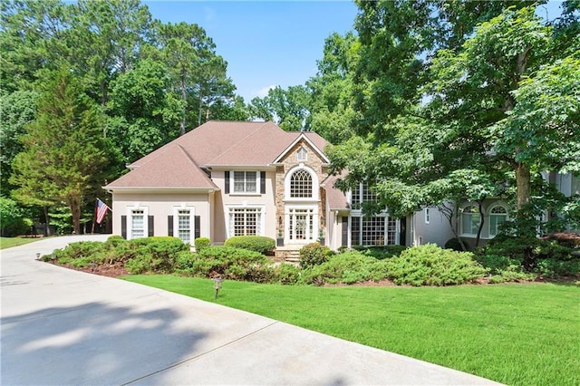 12160 Oak Hollow Way, Alpharetta, GA 30005 - view of front of house with concrete driveway, a front lawn, stone siding, and stucco siding