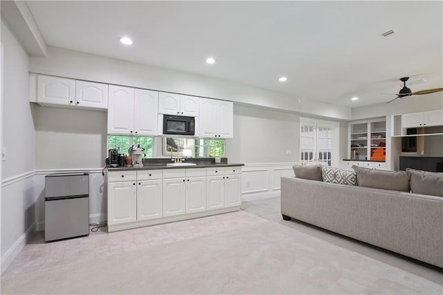 12160 Oak Hollow Way, Alpharetta, GA 30005 - living room featuring recessed lighting, ceiling fan, light colored carpet, wainscoting, and light tile patterned floors