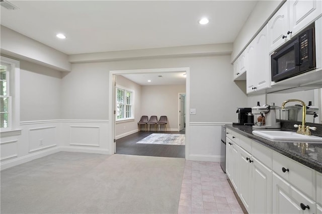 12160 Oak Hollow Way, Alpharetta, GA 30005 - kitchen with black microwave, white cabinets, recessed lighting, wainscoting, and dark stone counters