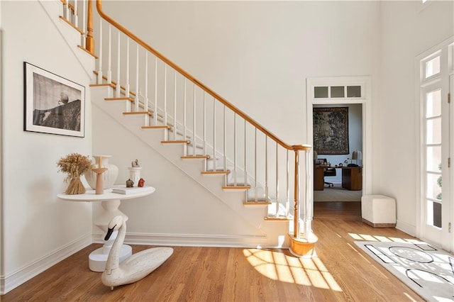 12160 Oak Hollow Way, Alpharetta, GA 30005 - entrance foyer featuring a high ceiling, wood finished floors, healthy amount of natural light, and stairs