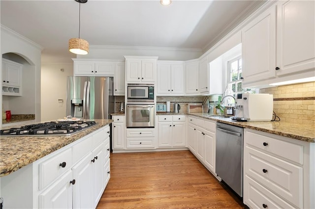 12160 Oak Hollow Way, Alpharetta, GA 30005 - kitchen featuring appliances with stainless steel finishes, crown molding, tasteful backsplash, white cabinets, and hanging light fixtures