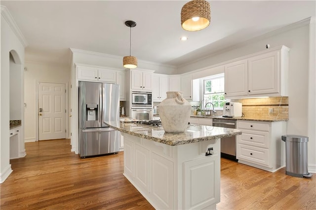 12160 Oak Hollow Way, Alpharetta, GA 30005 - kitchen featuring stainless steel appliances, white cabinetry, crown molding, light wood finished floors, and a kitchen island