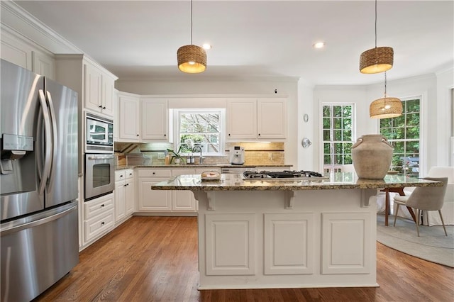 12160 Oak Hollow Way, Alpharetta, GA 30005 - kitchen featuring stainless steel appliances, crown molding, a breakfast bar area, healthy amount of natural light, and dark stone countertops