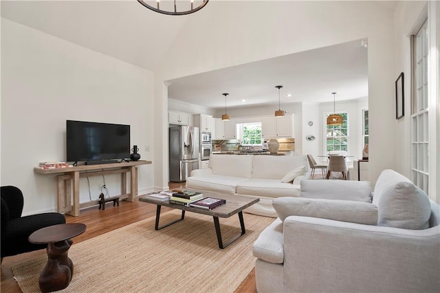 12160 Oak Hollow Way, Alpharetta, GA 30005 - living area featuring light wood finished floors, high vaulted ceiling, and recessed lighting
