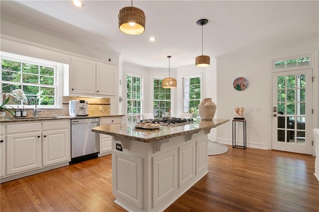 12160 Oak Hollow Way, Alpharetta, GA 30005 - kitchen featuring appliances with stainless steel finishes, white cabinets, light stone counters, light wood finished floors, and ornamental molding