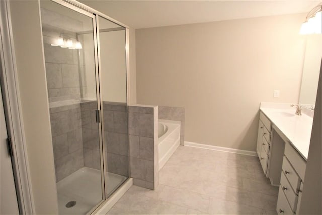 full bath with baseboards, a garden tub, a stall shower, and vanity