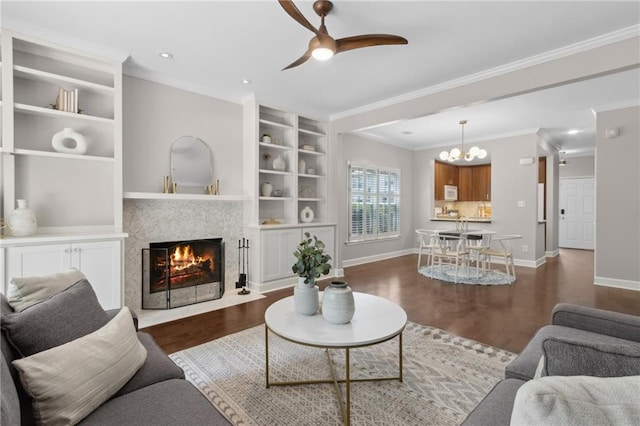 812 Dixie Ave NE, Atlanta, GA 30307 - living area featuring wood finished floors, a ceiling fan, crown molding, a fireplace with flush hearth, and a chandelier