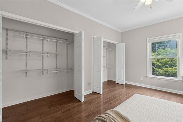 812 Dixie Ave NE, Atlanta, GA 30307 - unfurnished bedroom with two closets, ornamental molding, wood finished floors, and ceiling fan