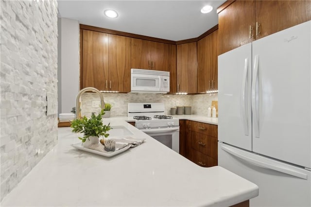 812 Dixie Ave NE, Atlanta, GA 30307 - kitchen with white appliances, light countertops, decorative backsplash, brown cabinets, and recessed lighting