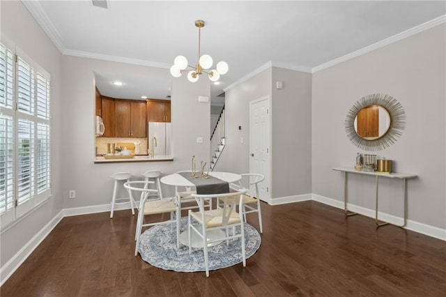 812 Dixie Ave NE, Atlanta, GA 30307 - dining area featuring wood finished floors, stairs, crown molding, and a chandelier