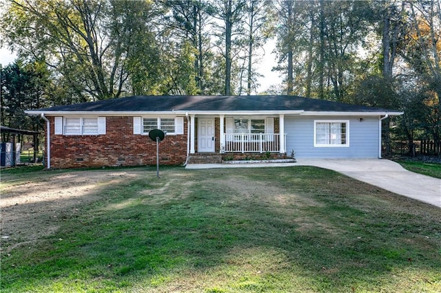 ranch-style home with covered porch and a front yard