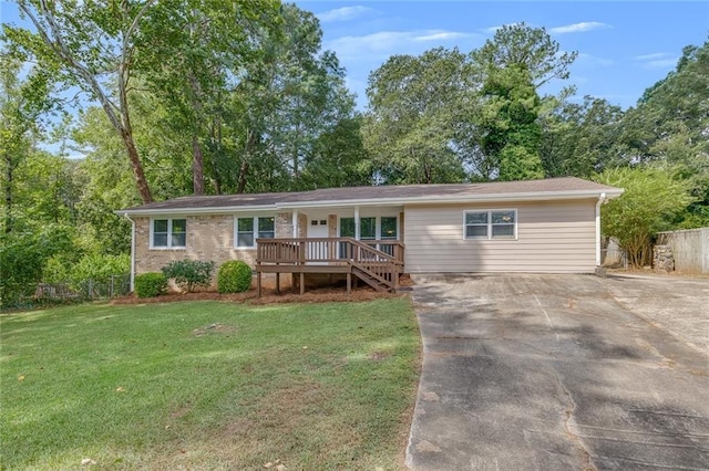 ranch-style home with a deck and a front lawn