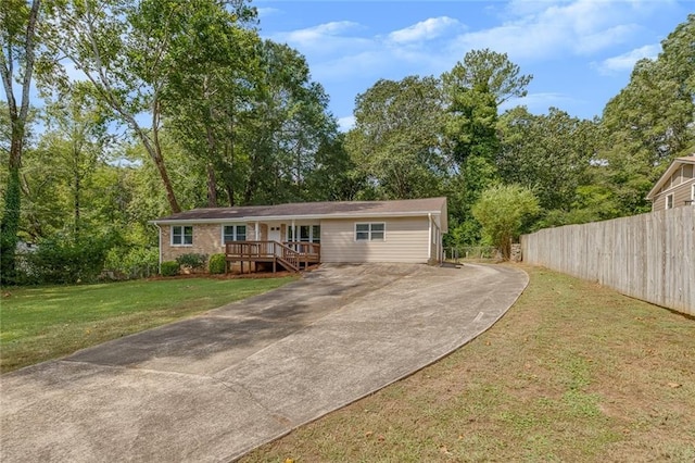 single story home featuring a deck and a front yard