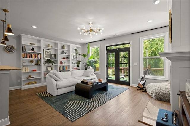 1744 Habershal Rd NW, Atlanta, GA 30318 - living room featuring plenty of natural light, a chandelier, french doors, wood finished floors, and recessed lighting