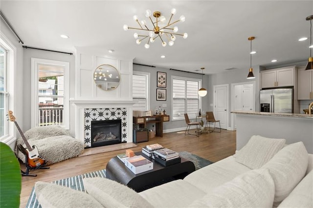 1744 Habershal Rd NW, Atlanta, GA 30318 - living room with plenty of natural light, a chandelier, wood finished floors, recessed lighting, and a fireplace