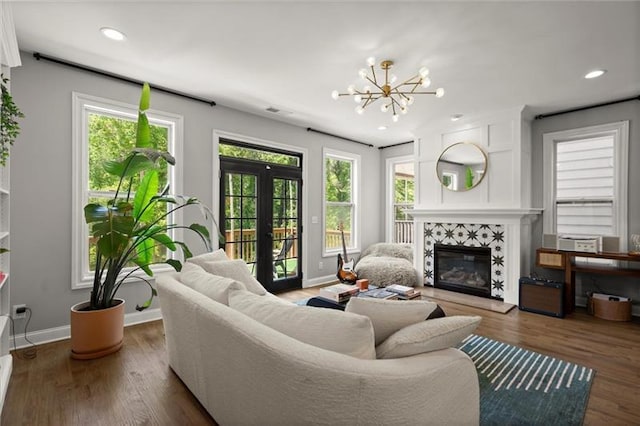 1744 Habershal Rd NW, Atlanta, GA 30318 - living room with a fireplace, a chandelier, french doors, recessed lighting, and wood finished floors