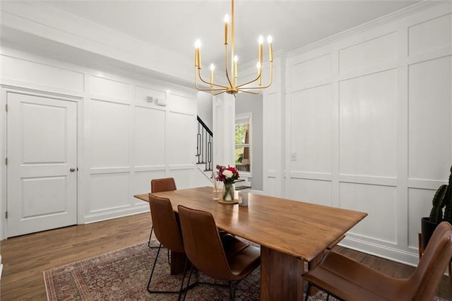 1744 Habershal Rd NW, Atlanta, GA 30318 - dining area featuring a decorative wall, stairs, a chandelier, wood finished floors, and ornamental molding