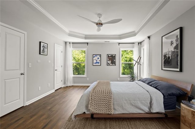 1744 Habershal Rd NW, Atlanta, GA 30318 - bedroom featuring a tray ceiling, multiple windows, dark wood-type flooring, ornamental molding, and baseboards