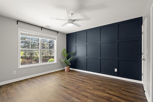 1744 Habershal Rd NW, Atlanta, GA 30318 - empty room featuring a decorative wall, dark wood finished floors, a ceiling fan, and baseboards