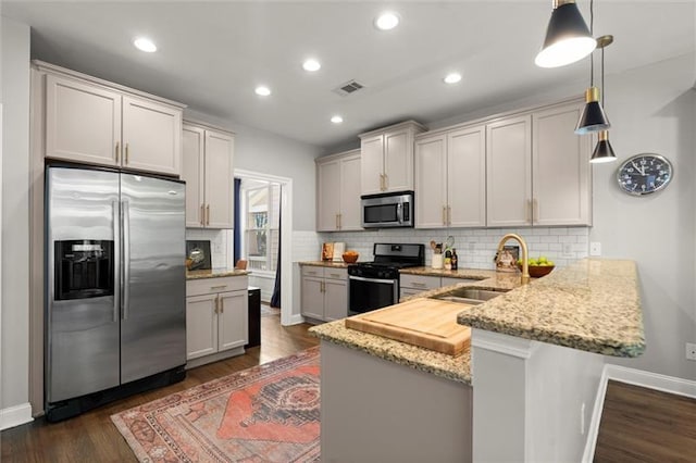 1744 Habershal Rd NW, Atlanta, GA 30318 - kitchen with stainless steel appliances, a peninsula, a sink, backsplash, and light stone countertops
