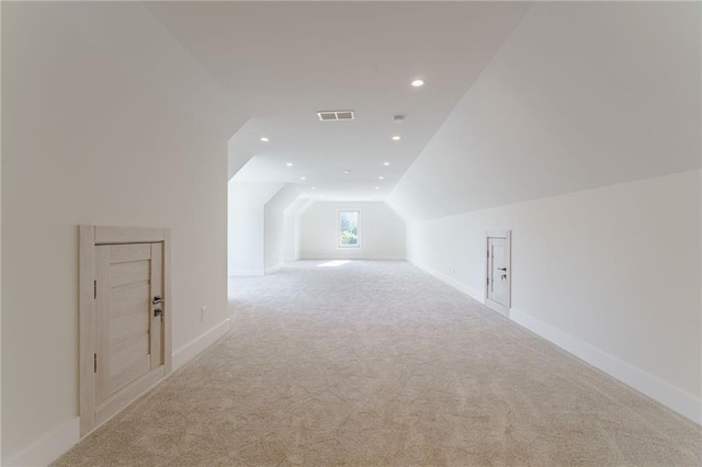 bonus room featuring light colored carpet and vaulted ceiling