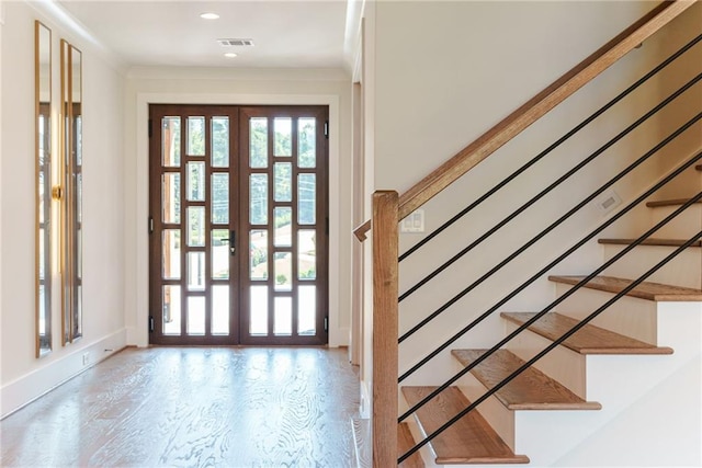 entryway with french doors and light hardwood / wood-style flooring