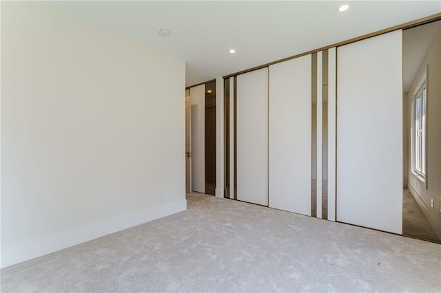 unfurnished bedroom featuring light carpet