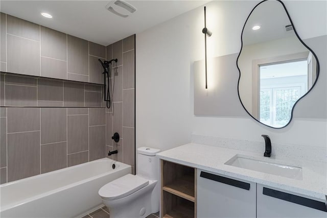 full bathroom featuring vanity, toilet, and tiled shower / bath