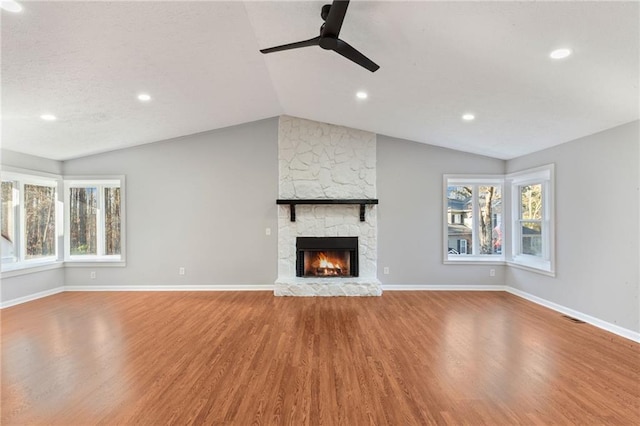 unfurnished living room featuring baseboards, lofted ceiling, wood finished floors, and a ceiling fan