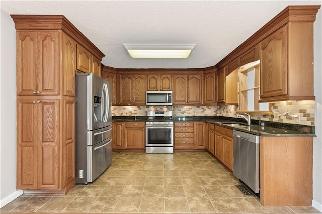 kitchen with a sink, stainless steel appliances, brown cabinets, and backsplash