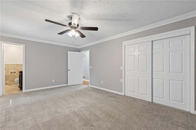 unfurnished bedroom with a closet, a textured ceiling, and crown molding